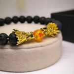 Laavakivist helmekäevõru draakonitega